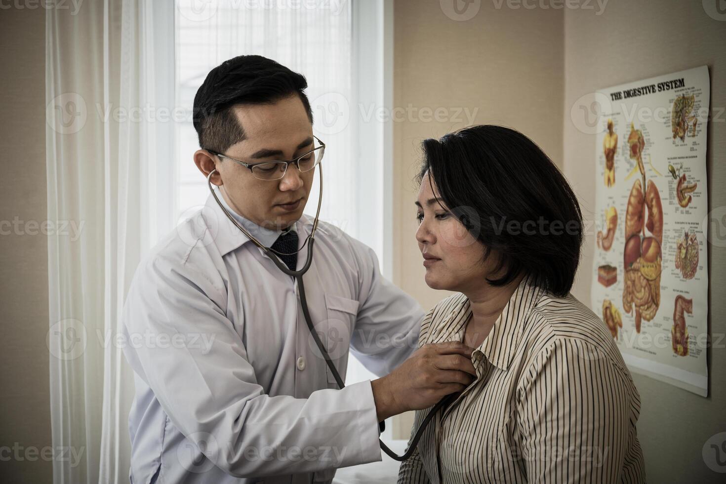 médico en blanco uniforme vestido escucha pulmón y corazón paciente con estetoscopio foto