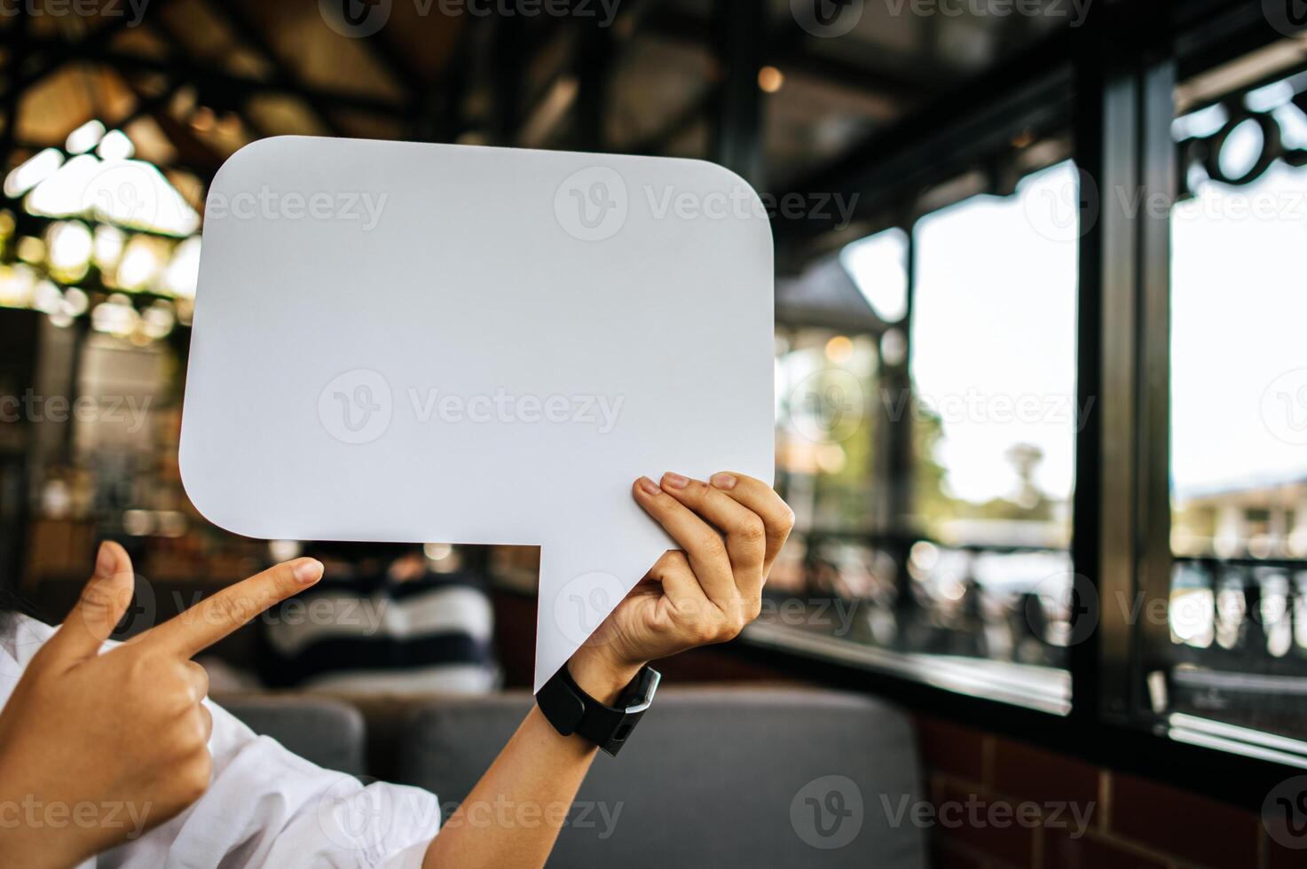 photo a young woman in a white shirt holding a thought box symbol