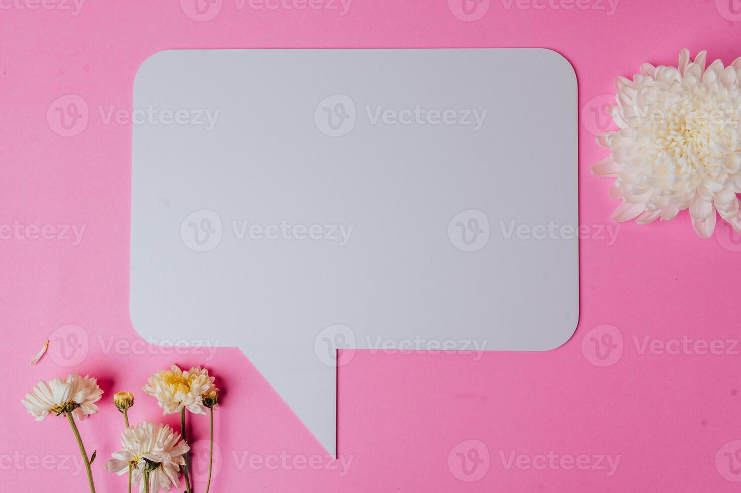 blank paper with flower on pink background photo