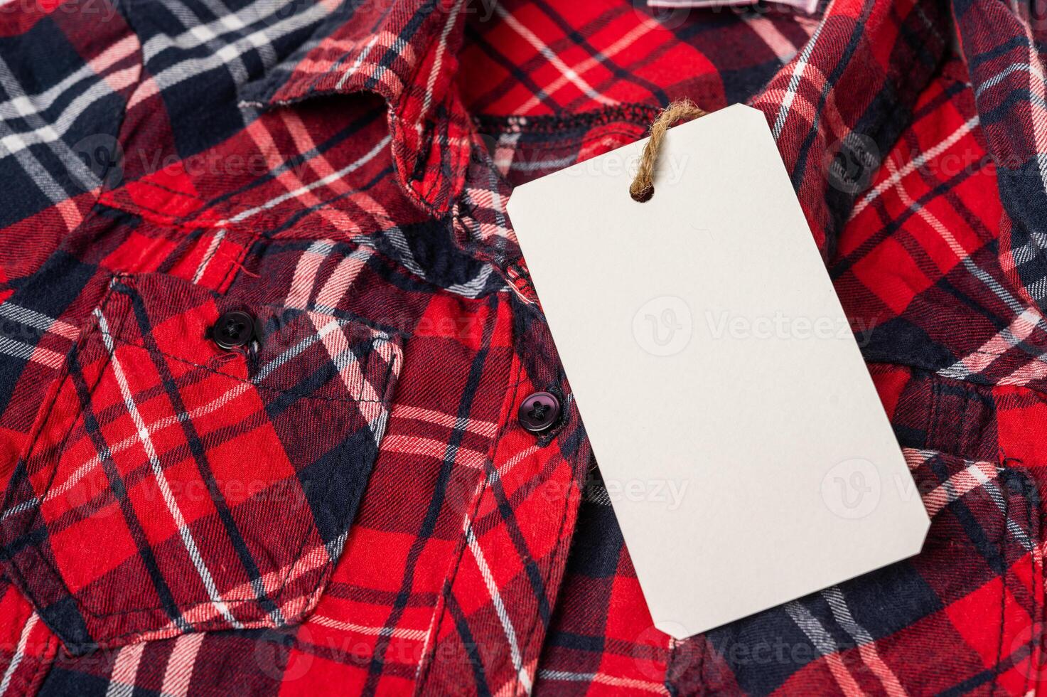 blank price tag label on plaid shirt photo