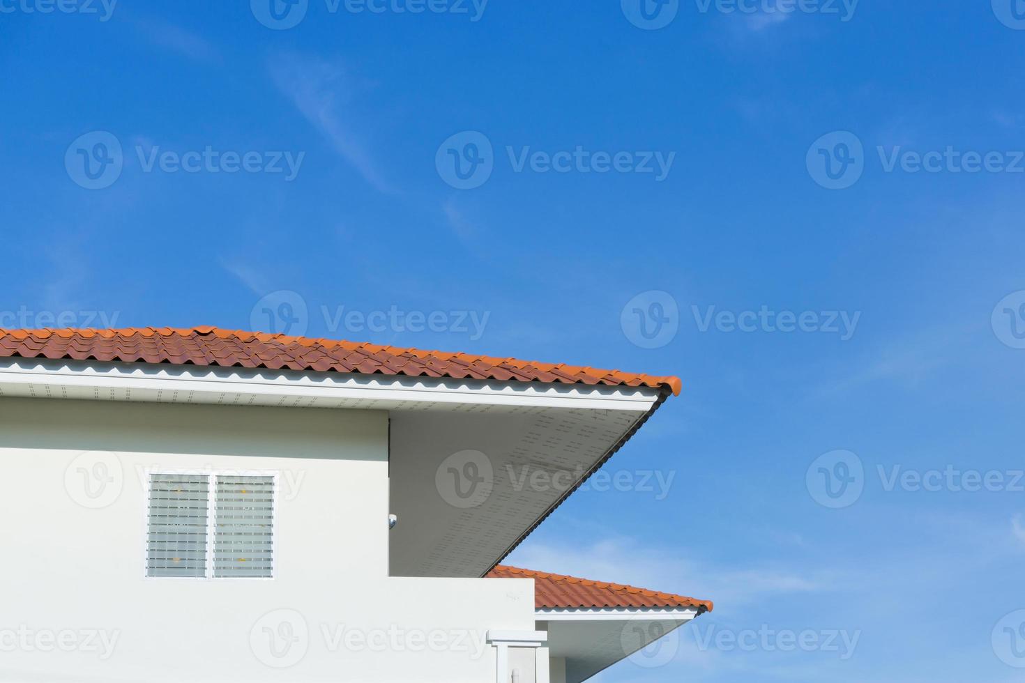 House roof with large windows on blue sky background,generic view to facade of a new modern building with blue sky,asia house style photo