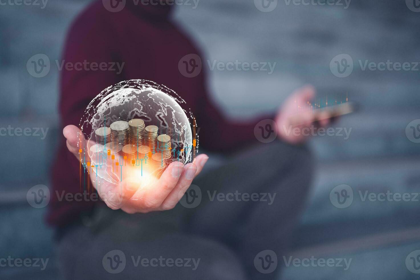 investment and finance concept, businessman holding virtual glob and trading graph with blurred coins on hand, stock market, profits and business growth. photo