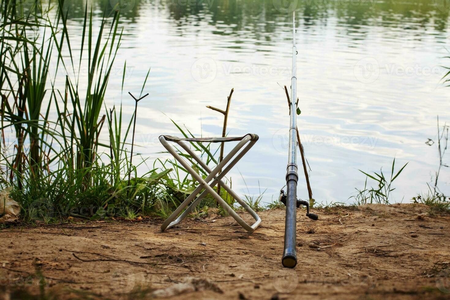 fishing pole on the river bank 20641597 Stock Photo at Vecteezy