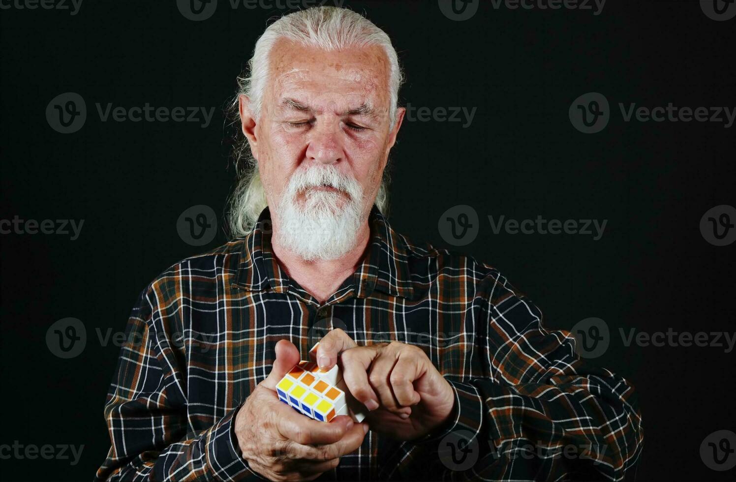 Old Man is Playing with Rubiks Cube Game photo