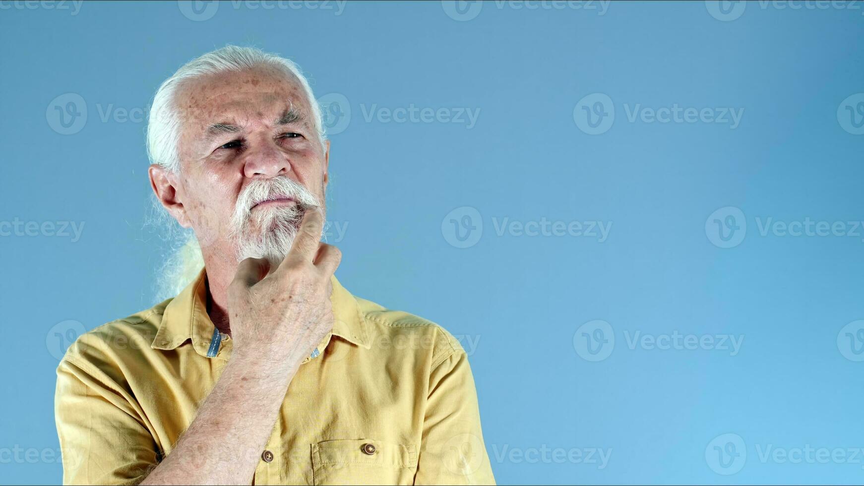 The Old Man Holds His Beard and Think photo