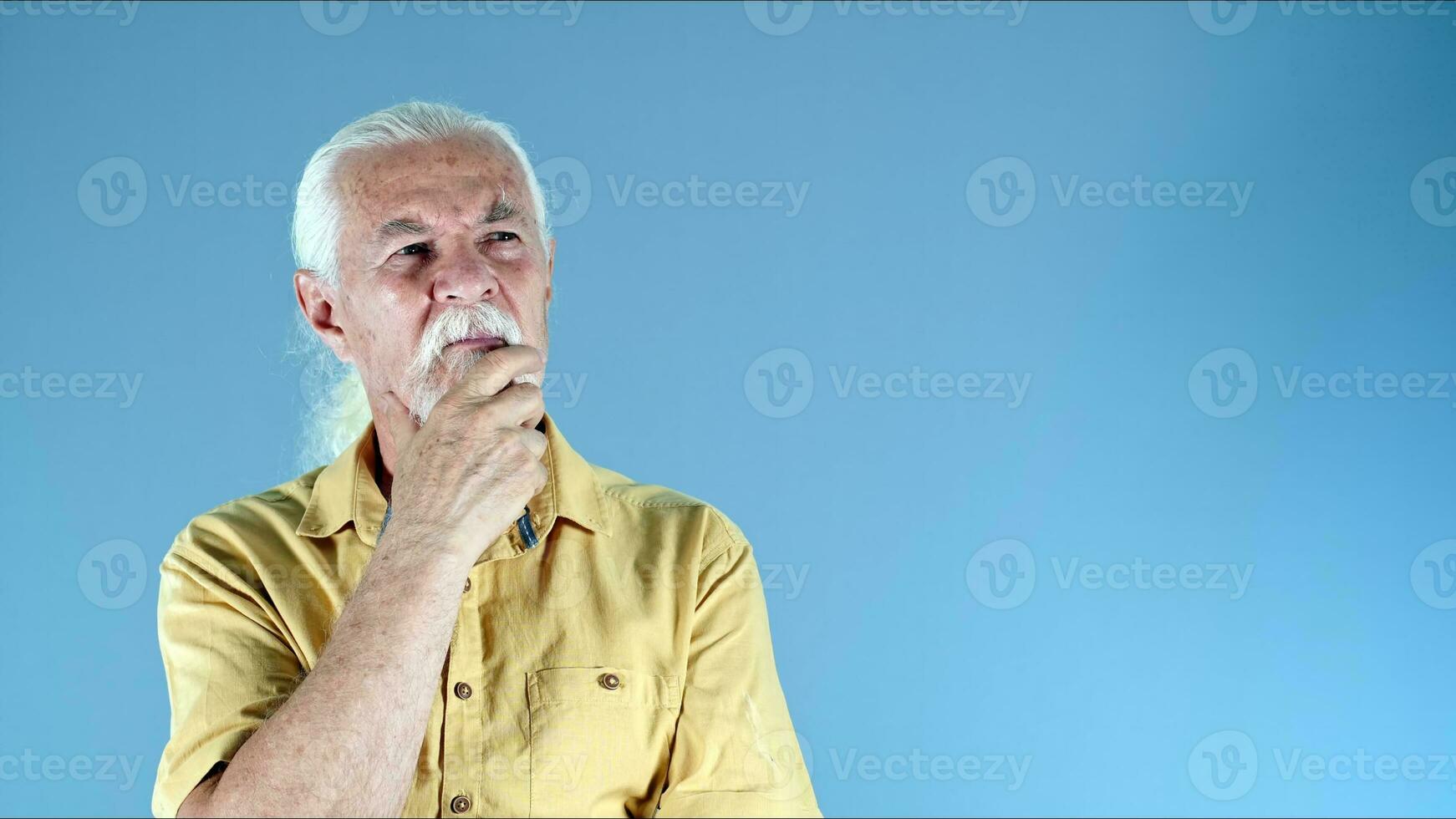 The Old Man Holds His Beard and Think photo