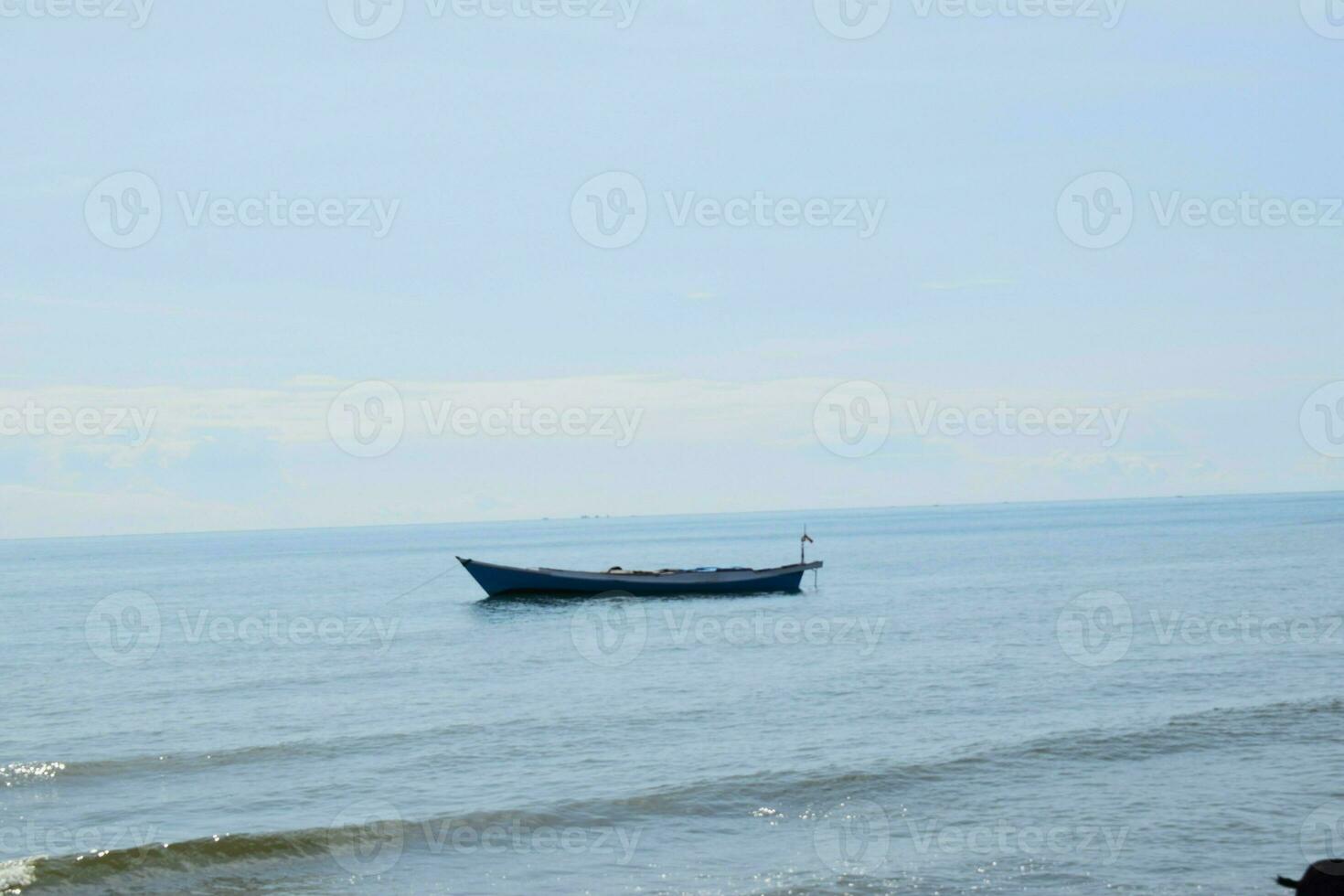 Wooden fishing boat in the blue sea, going to the ocean for fish. photo