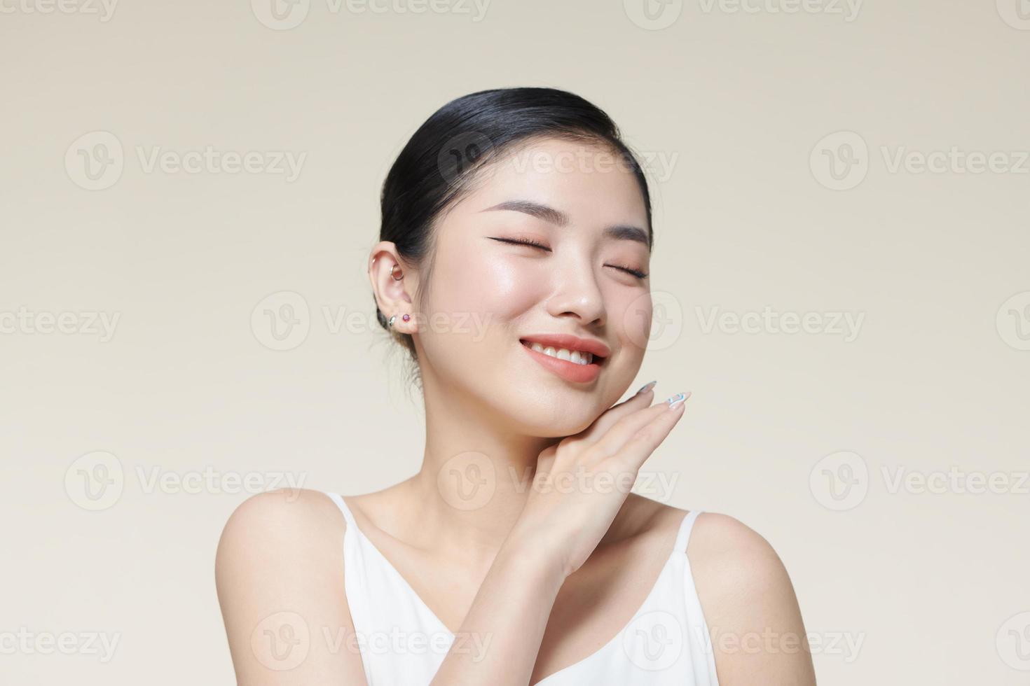 Smiling asian woman touching healthy skin portrait photo