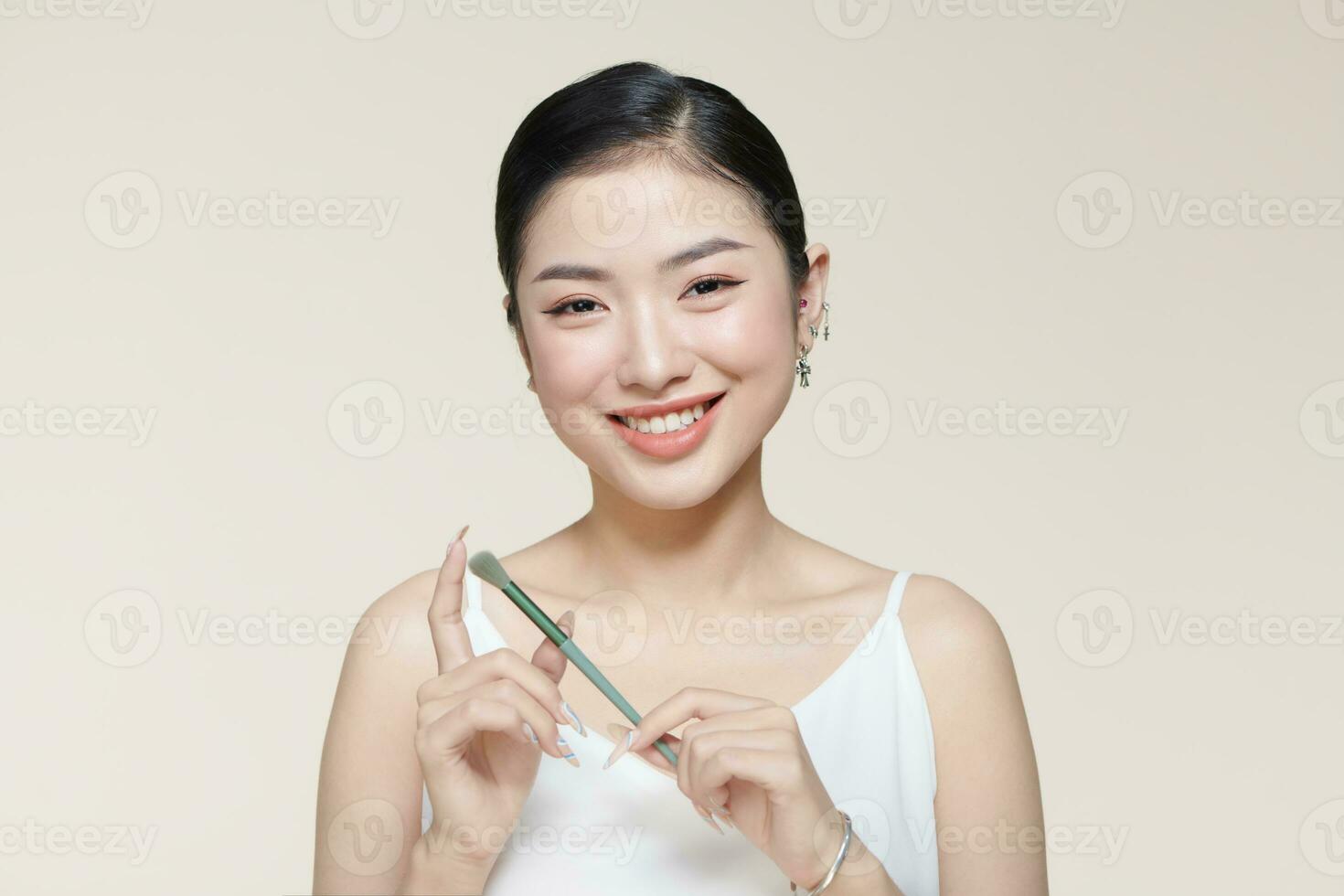 Enchanting young girl with brush for eyeshadow. photo