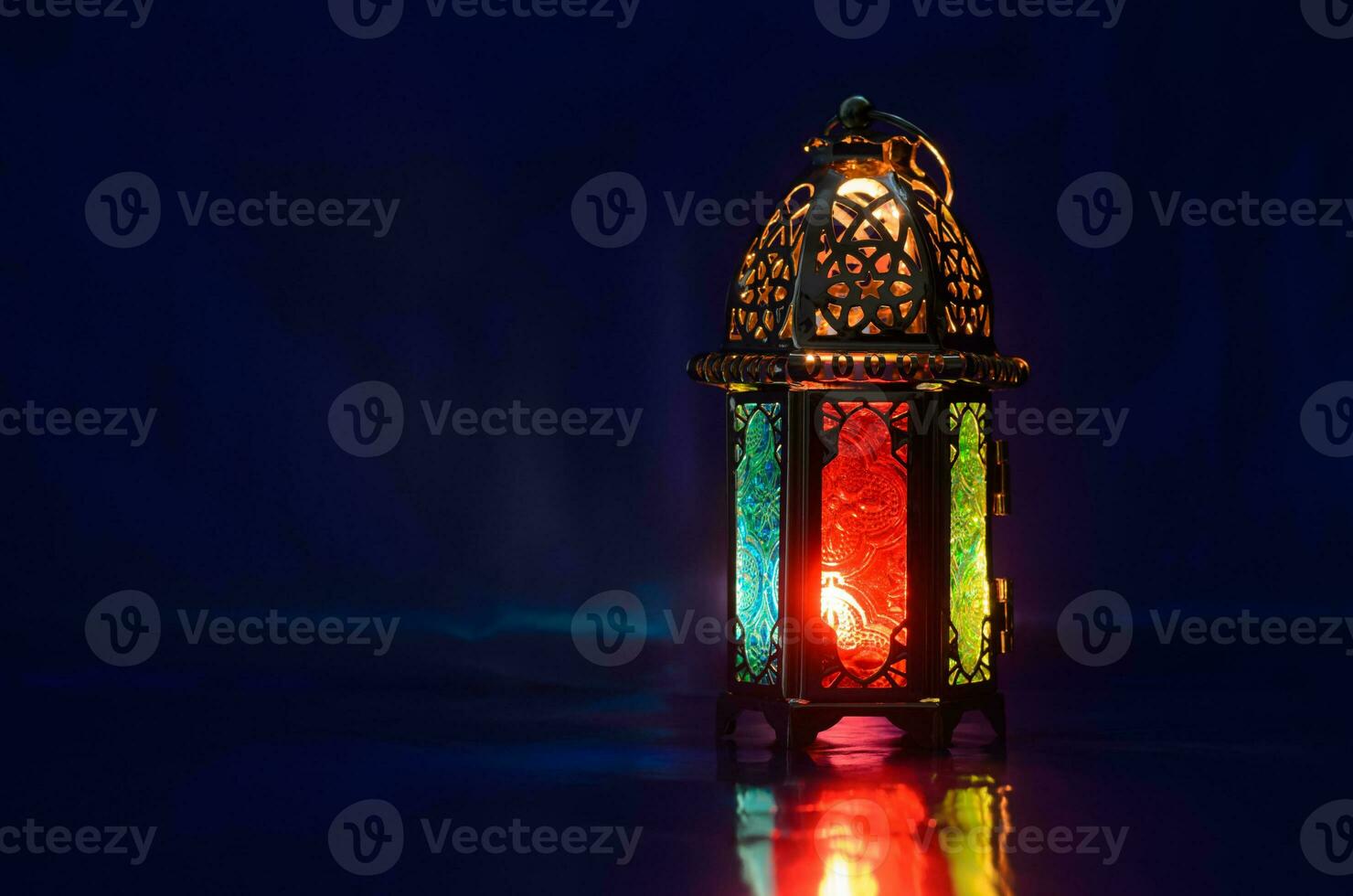 Lantern puts on table with dark blue background for the Muslim feast of the holy month of Ramadan Kareem. photo