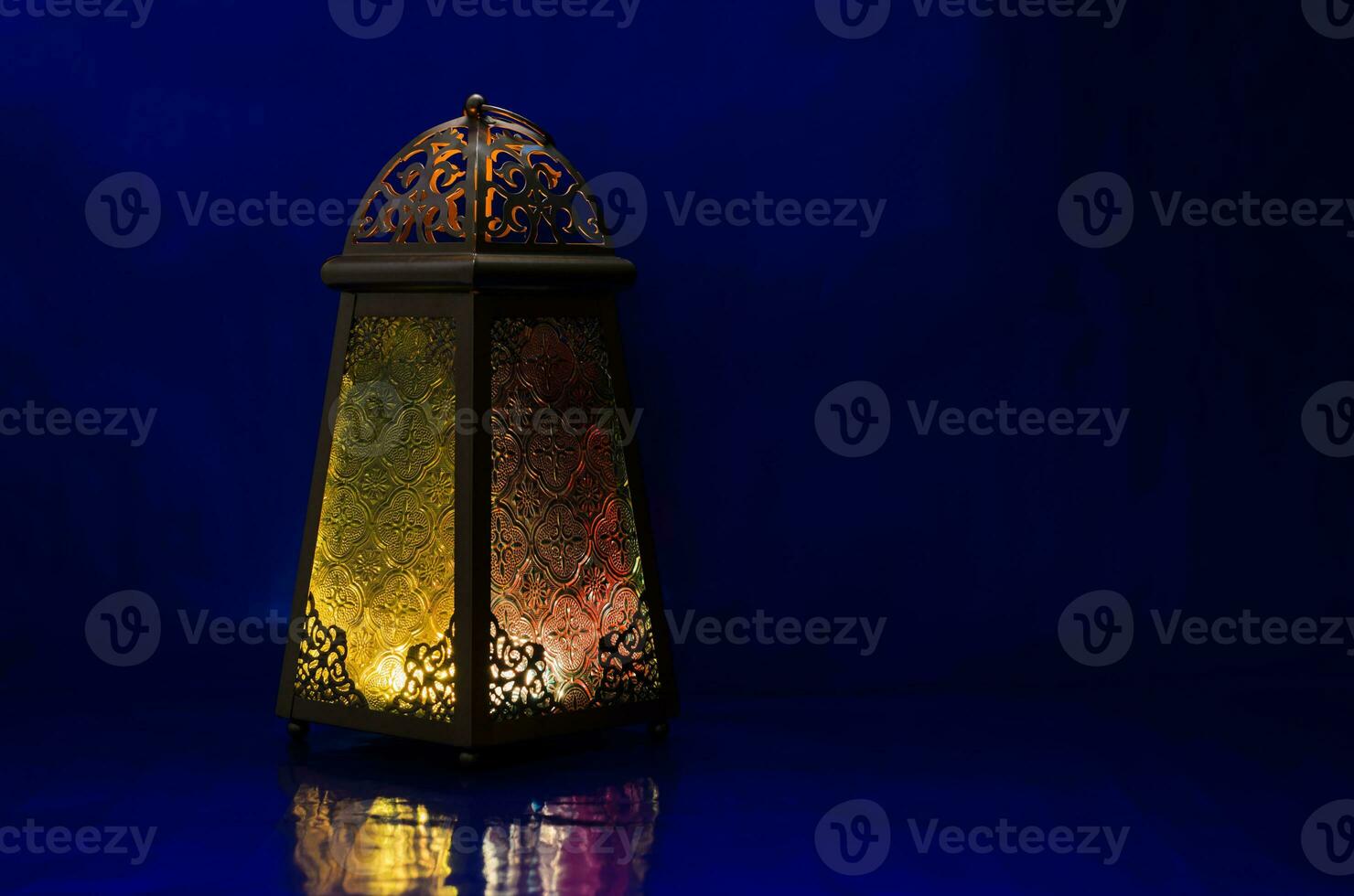 Lantern puts on table with dark blue background for the Muslim feast of the holy month of Ramadan Kareem. photo