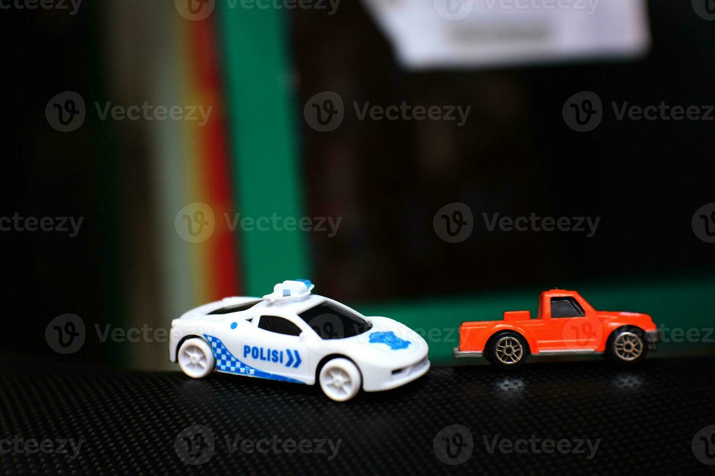Concept photo of a toy police car chasing an orange car