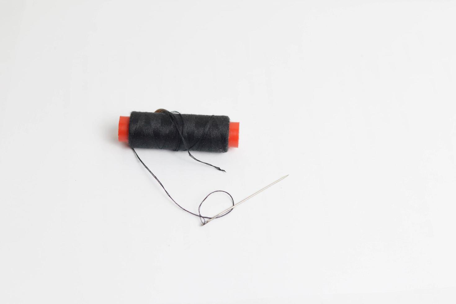 Spool of black sewing thread on a white background photo