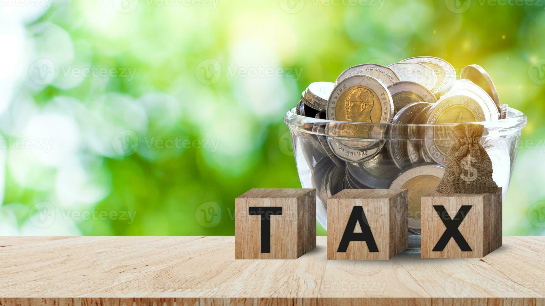 Wooden blocks with the words Tax and US dollar money bag and coins, Taxes payment concept. Tax evasion. Taxation. Business and finance. photo