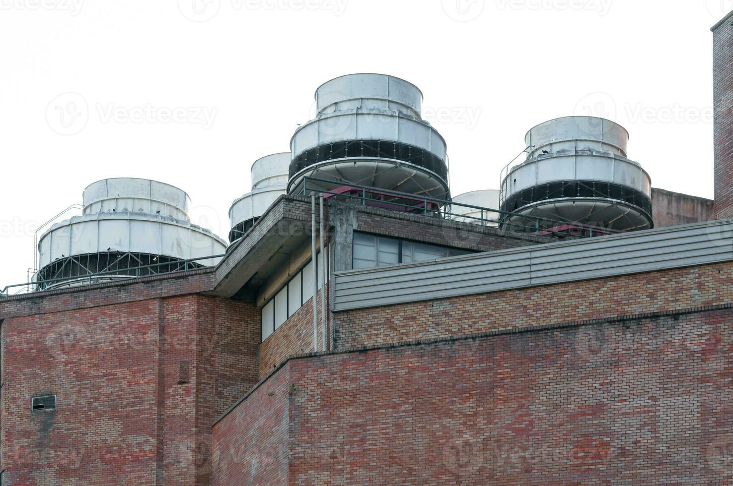 Commercial Air conditioners On Top Of brick wall Building photo