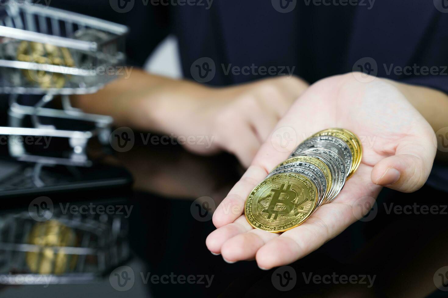 Bitcoin coins in the hand of a business women photo