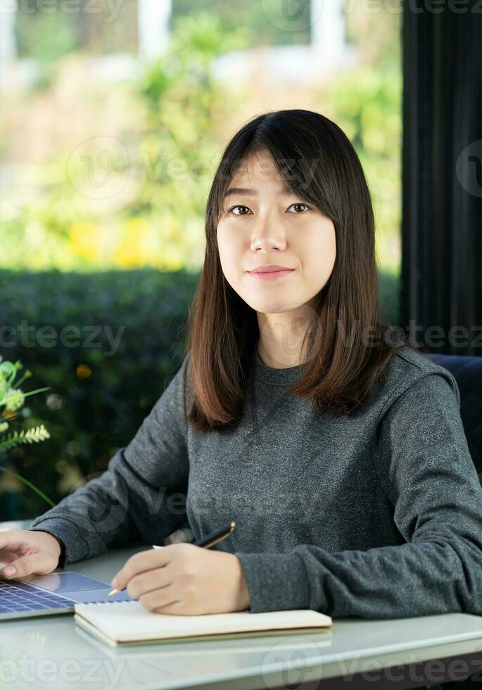 Teenage student using laptop doing homework at home photo