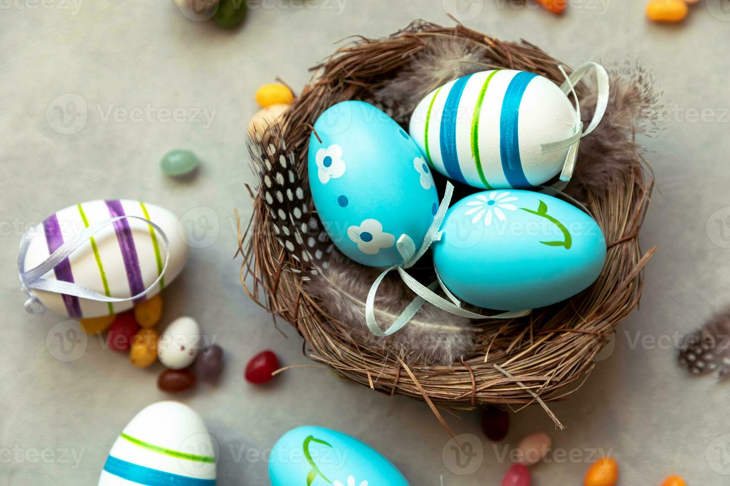 Happy Easter concept. Preparation for holiday. Colorful decorated blue easter eggs in nest on concrete stone grey background. Simple minimalism flat lay top view. Postcard background banner on Easter. photo