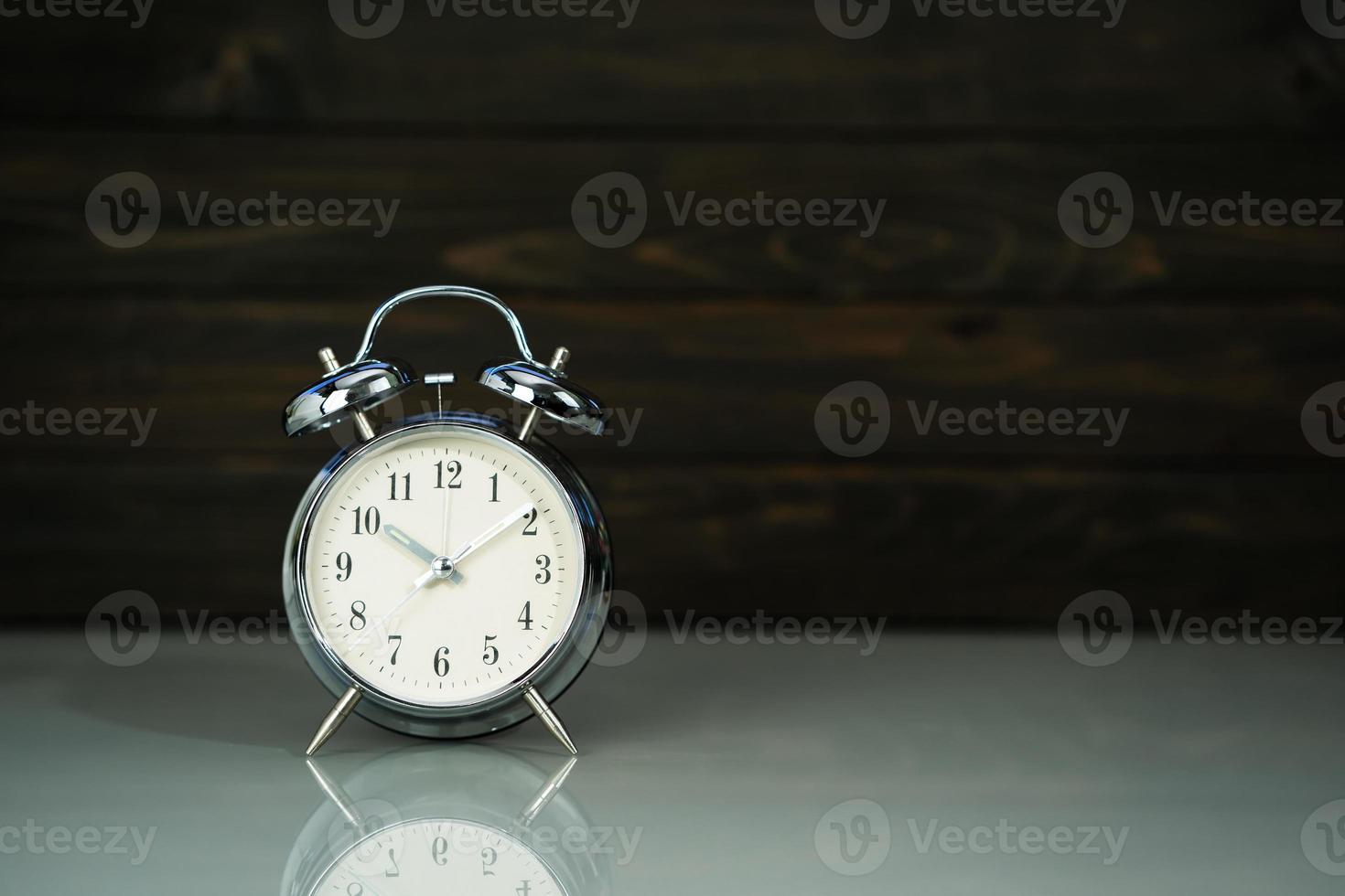 Retro alarm clock on table photo