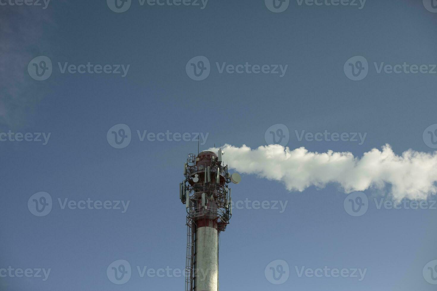 Boiler station pipe. Smoke from chimney. Industrial zone. Steam removal from plant. photo