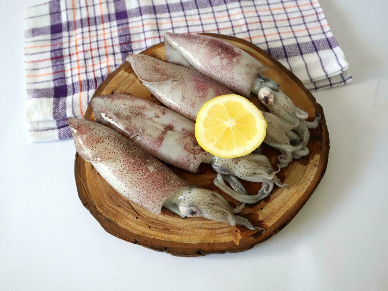 fresh squid that is on the wood and ready to be cooked photo