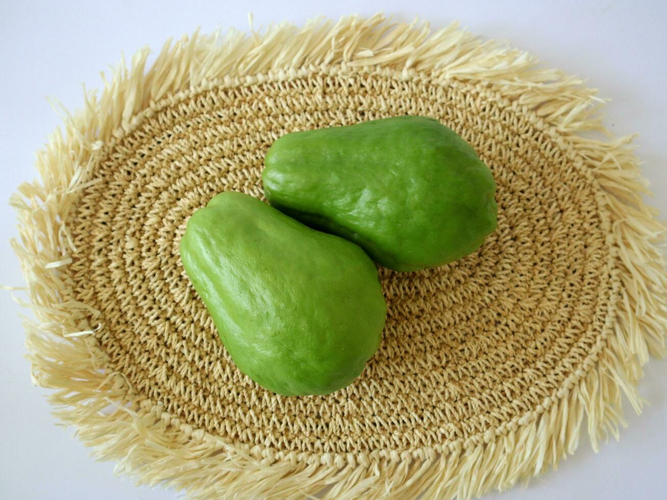 fresh chayote placed on a textured background photo