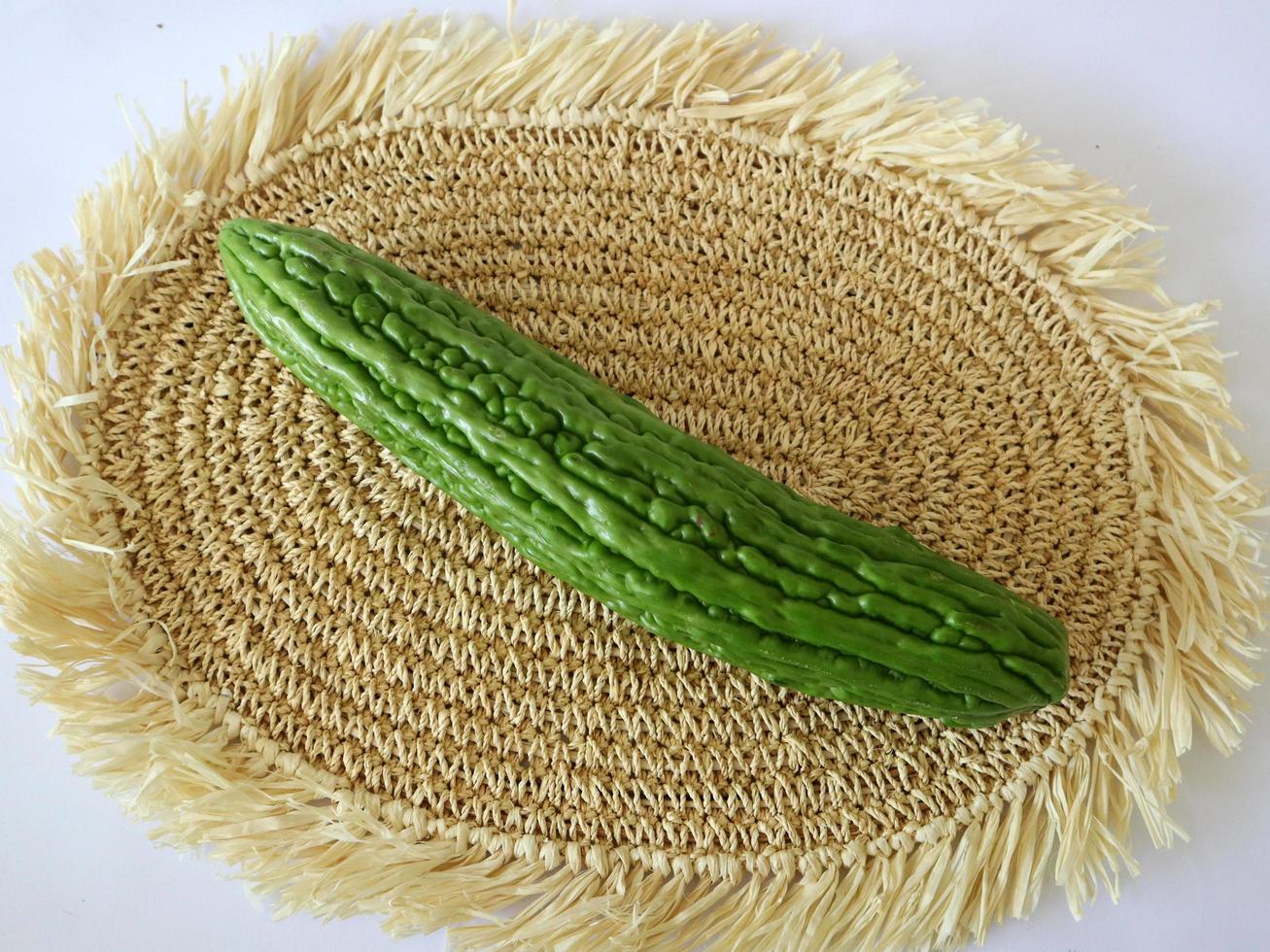 Fresh green bitter gourd with a textured background photo