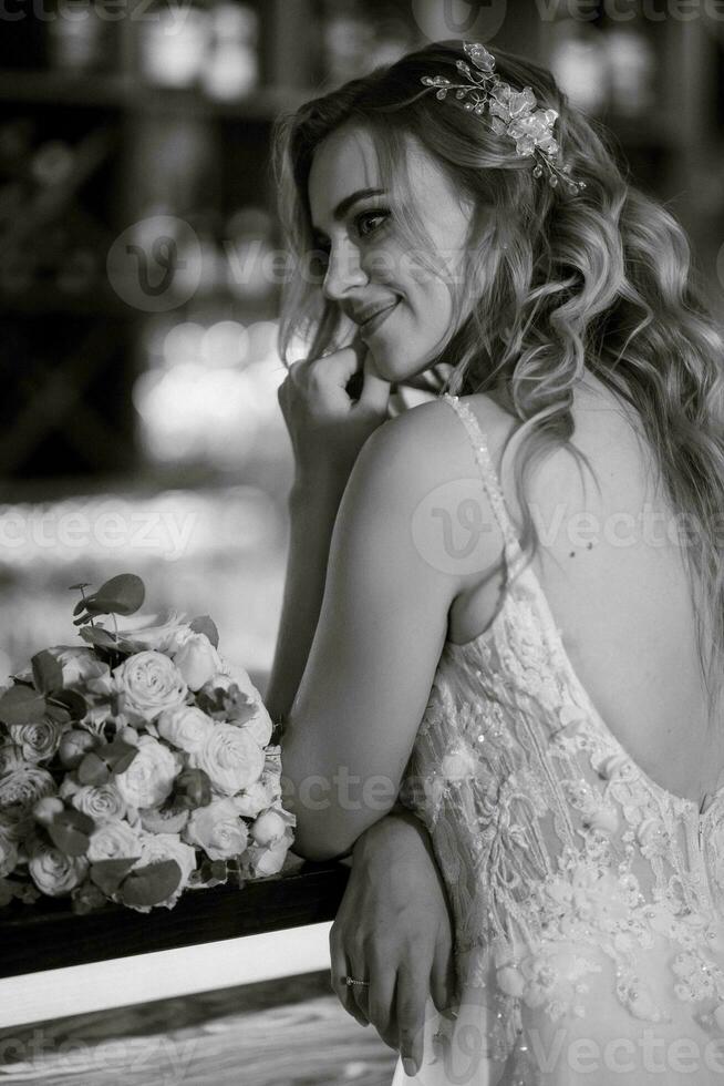 blonde bride in a bar near with a wedding bouquet photo