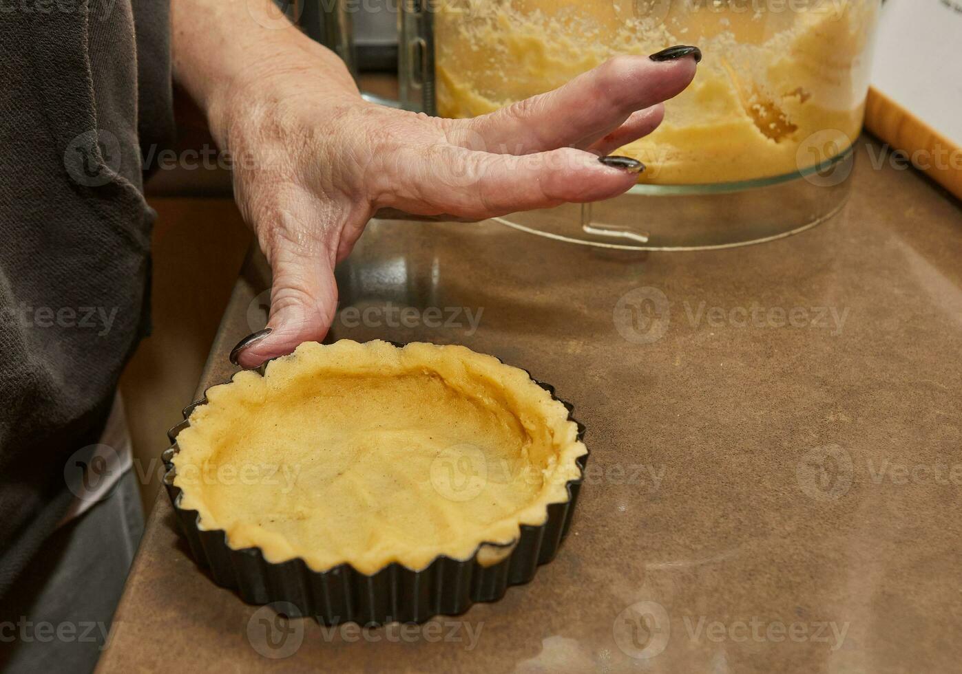 Process of making the base for Round Cream Pie with Chocolate and Strawberries. French recipe photo