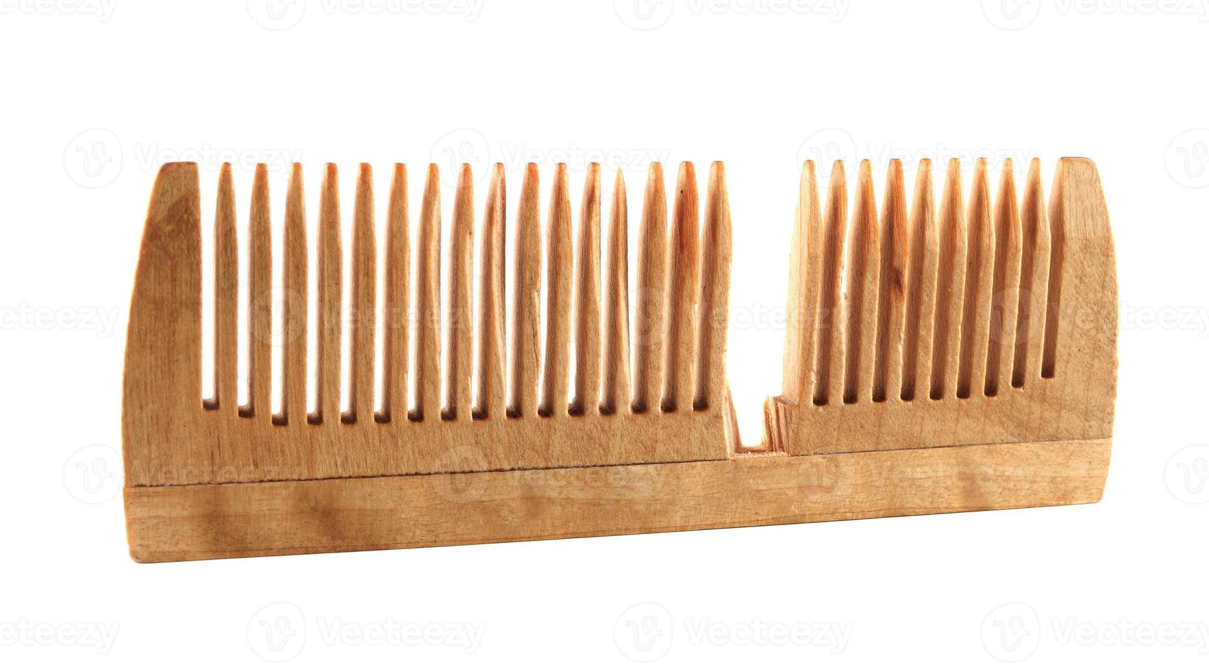 Broken wooden comb isolated on white background. photo