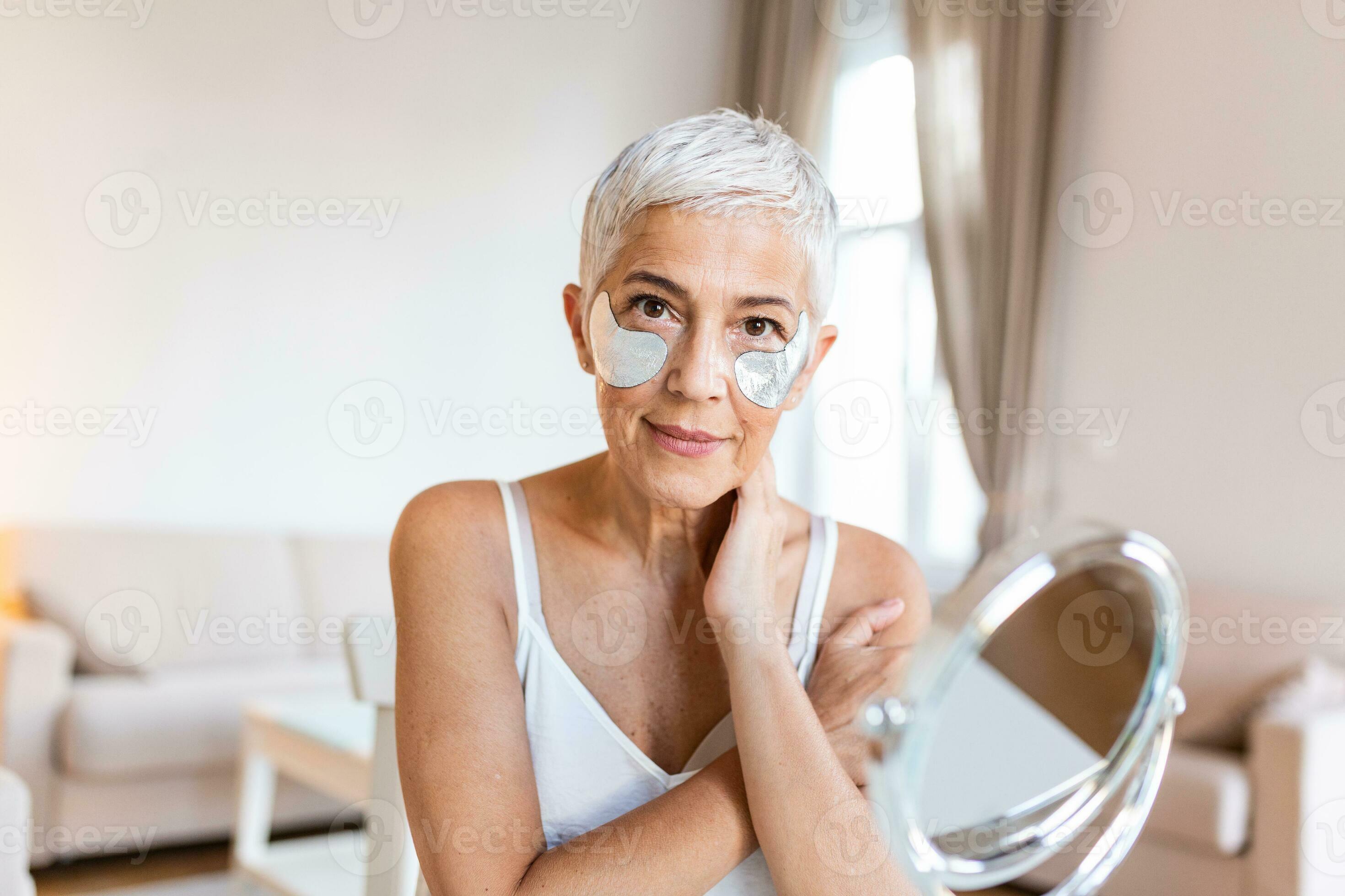 Portrait of pretty, nice grandmother with eye patches, having bags