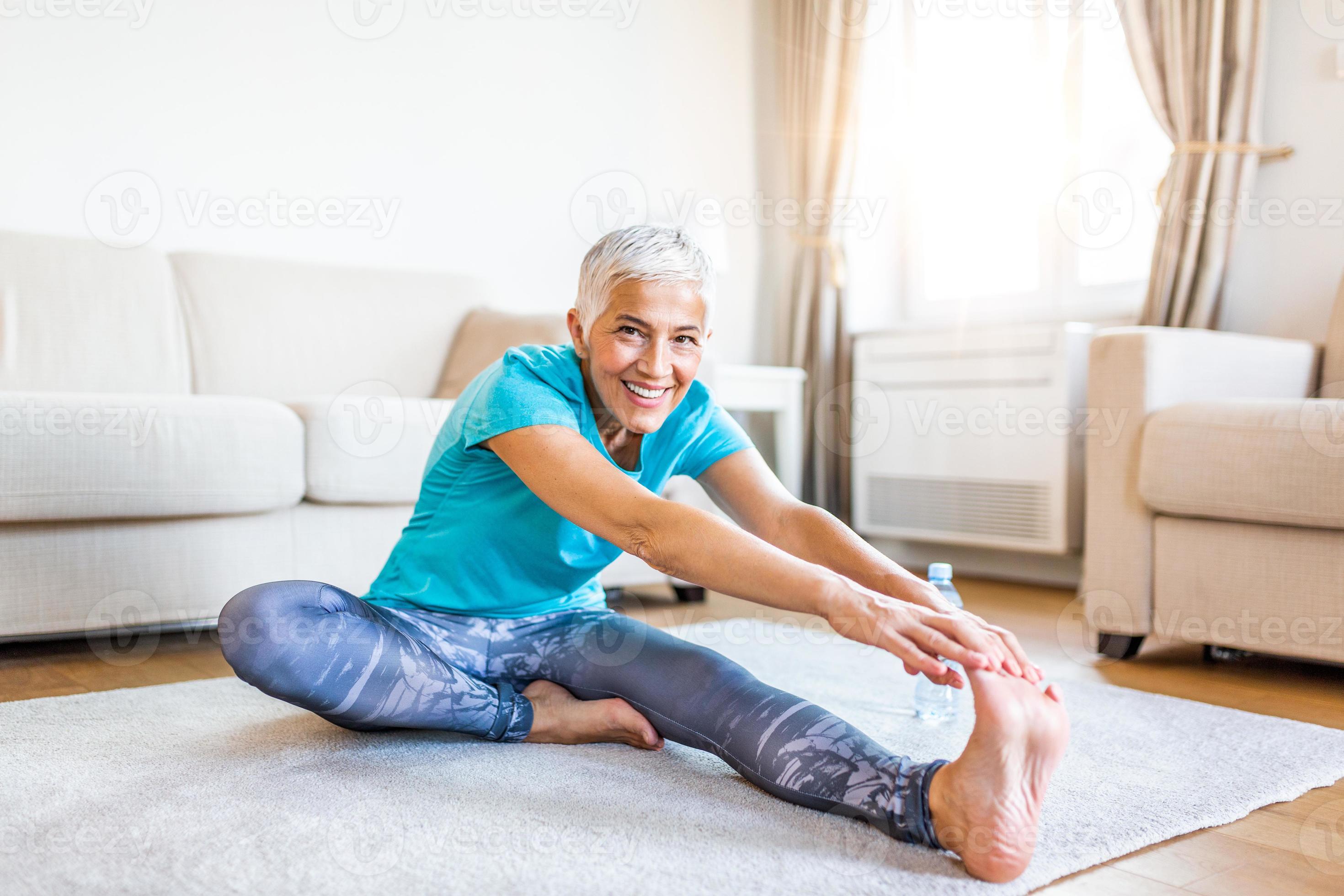senior woman doing warmup workout at home. Fitness woman doing