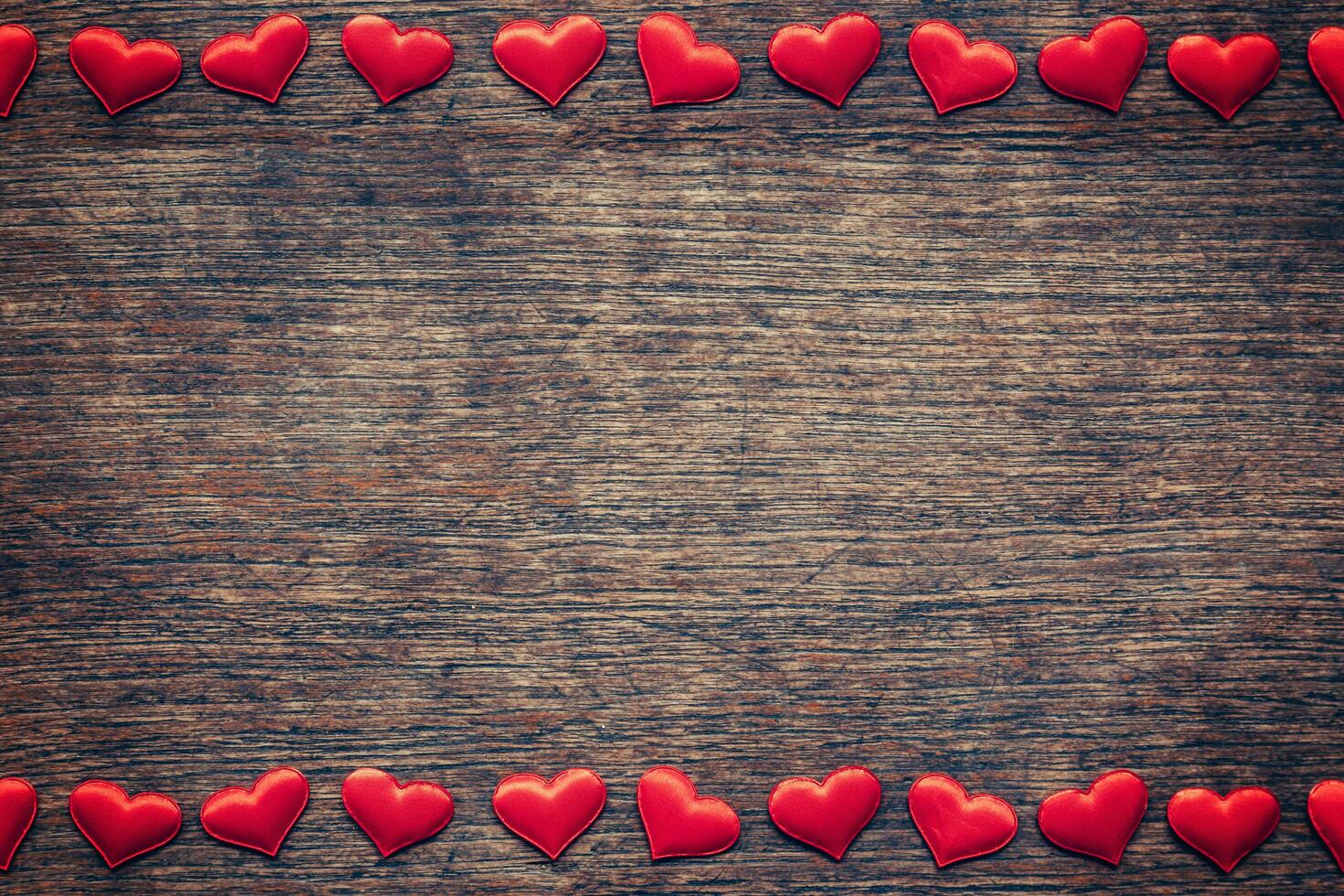 Red heart on wood background with space for Valentine Day. photo
