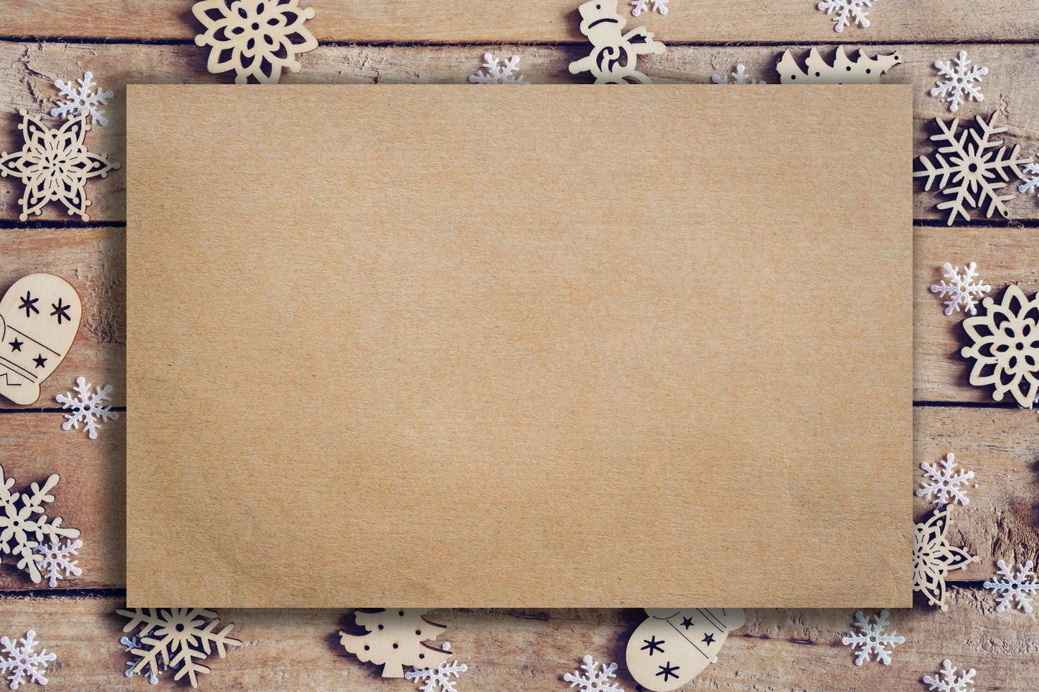 Wooden brown christmas background with snowflakes and old brown paper with space. photo