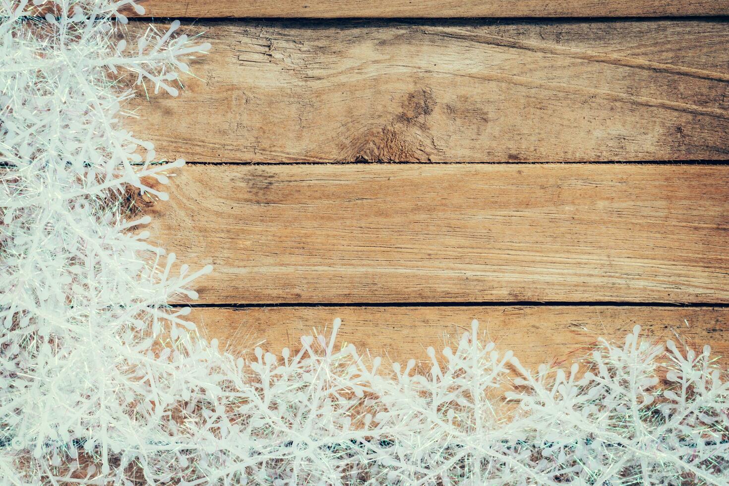 Wooden brown christmas background and white snowflakes with space. photo