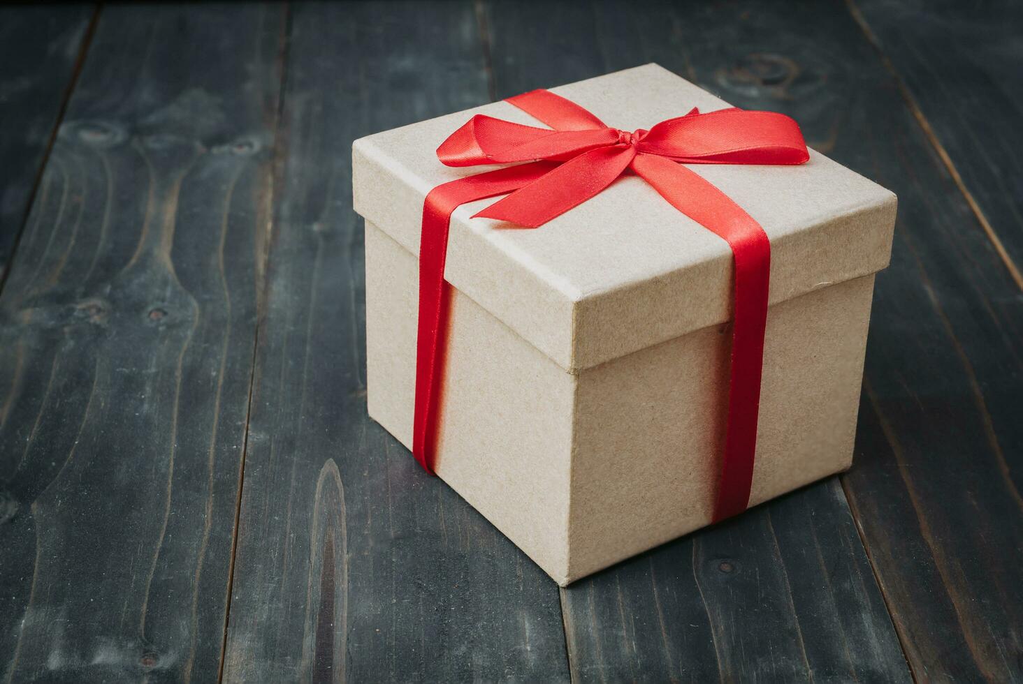 brown gift box on wooden table background with copy space. photo