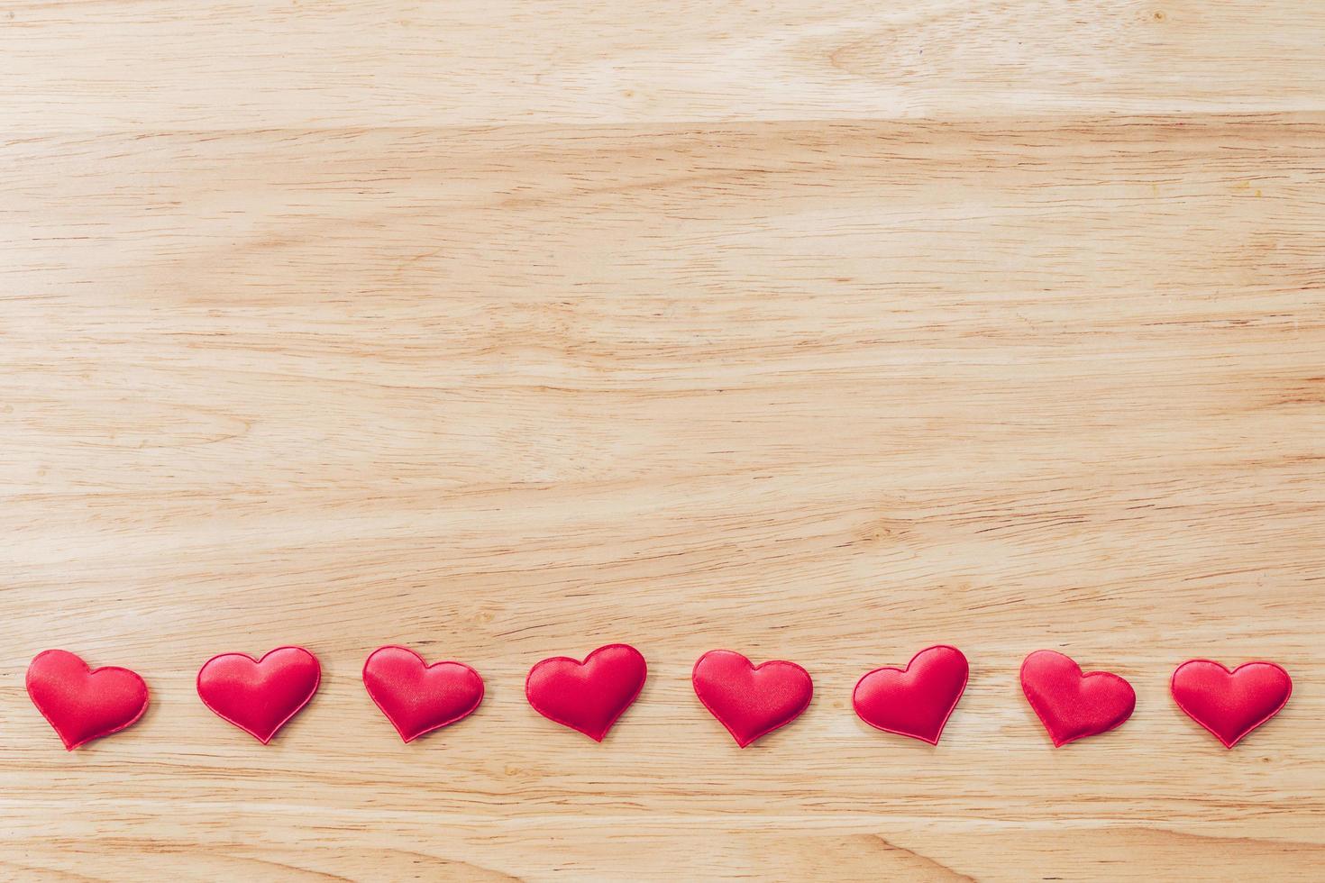 Top view red heart on wood table background with copy space. photo
