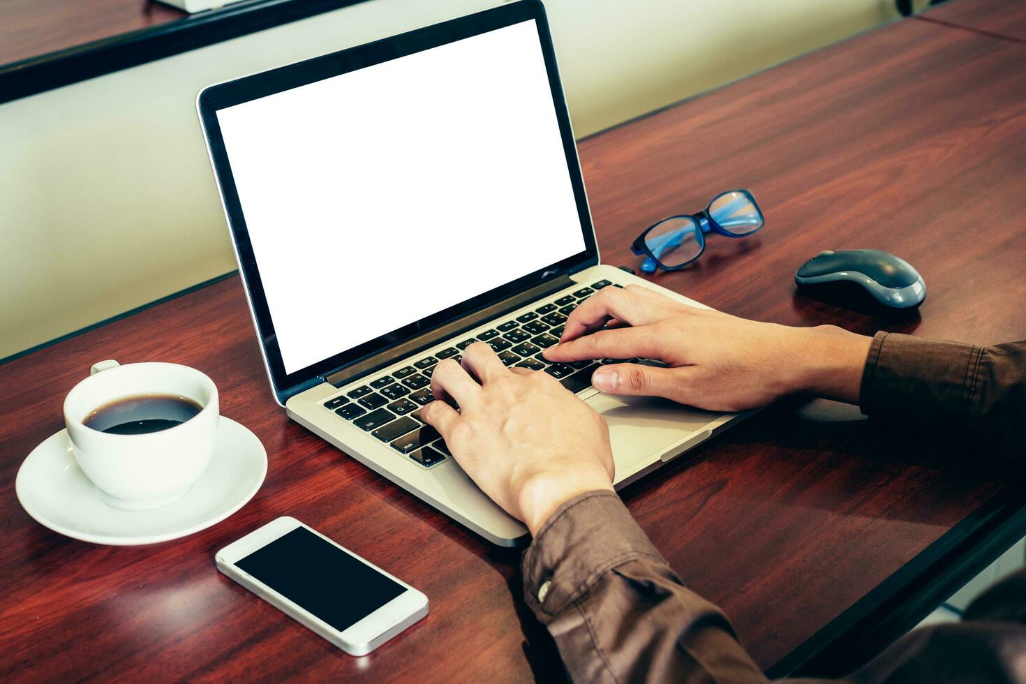 Business man using laptop on wood table in office. photo