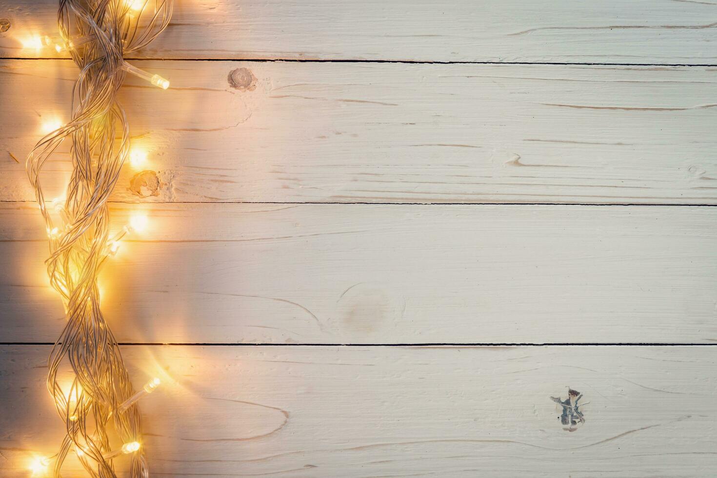 christmas background and lights garland on wood background with space. photo