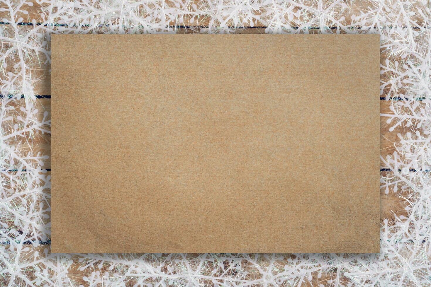Wooden brown christmas background with snowflakes and old brown paper with space. photo