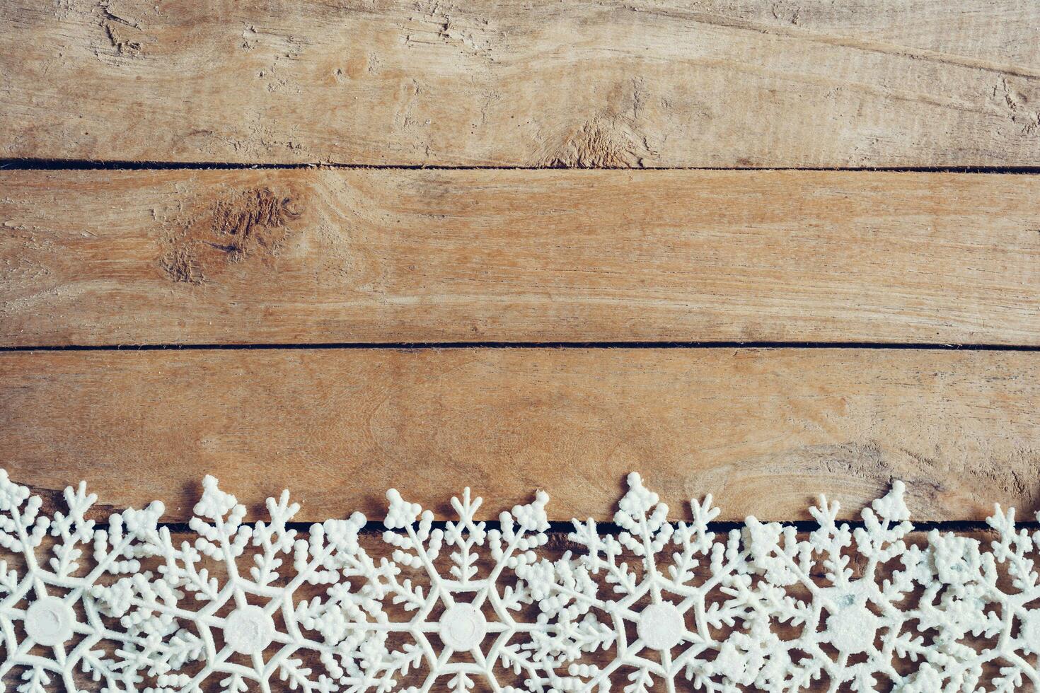Wooden brown christmas background with snowflakes and christmas decoration. photo