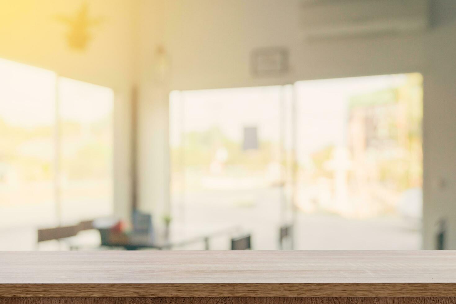 Empty wooden table top with blurred modern coffee shop background for product display and montage. photo
