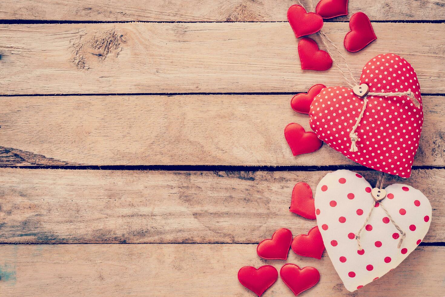 Heart fabric frame on wooden table background. photo