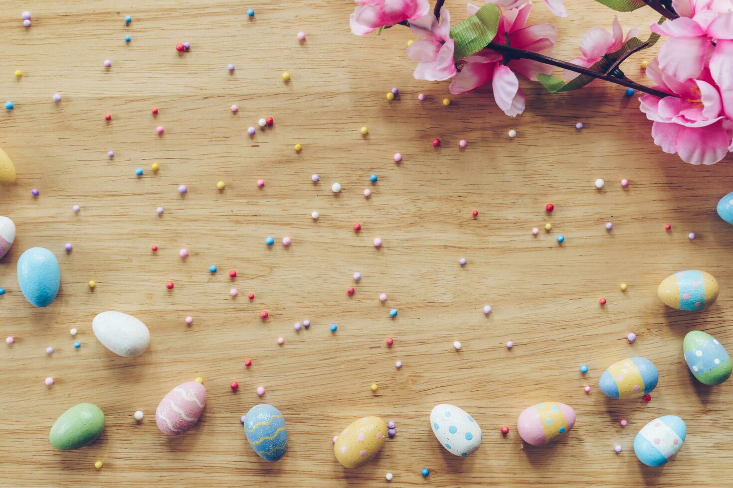 Easter eggs on on wood background top view with natural light. Flat lay style. photo