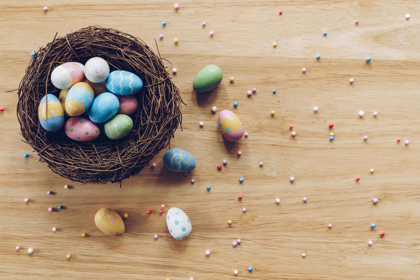 Easter eggs on on wood background top view with natural light. Flat lay style. photo