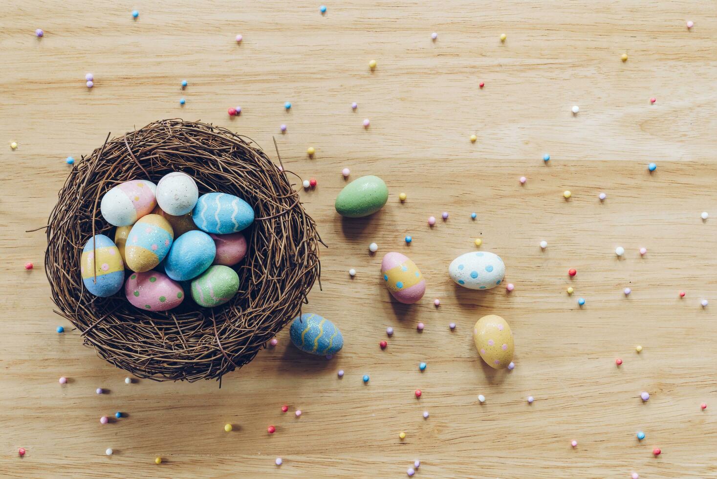 Easter eggs on on wood background top view with natural light. Flat lay style. photo