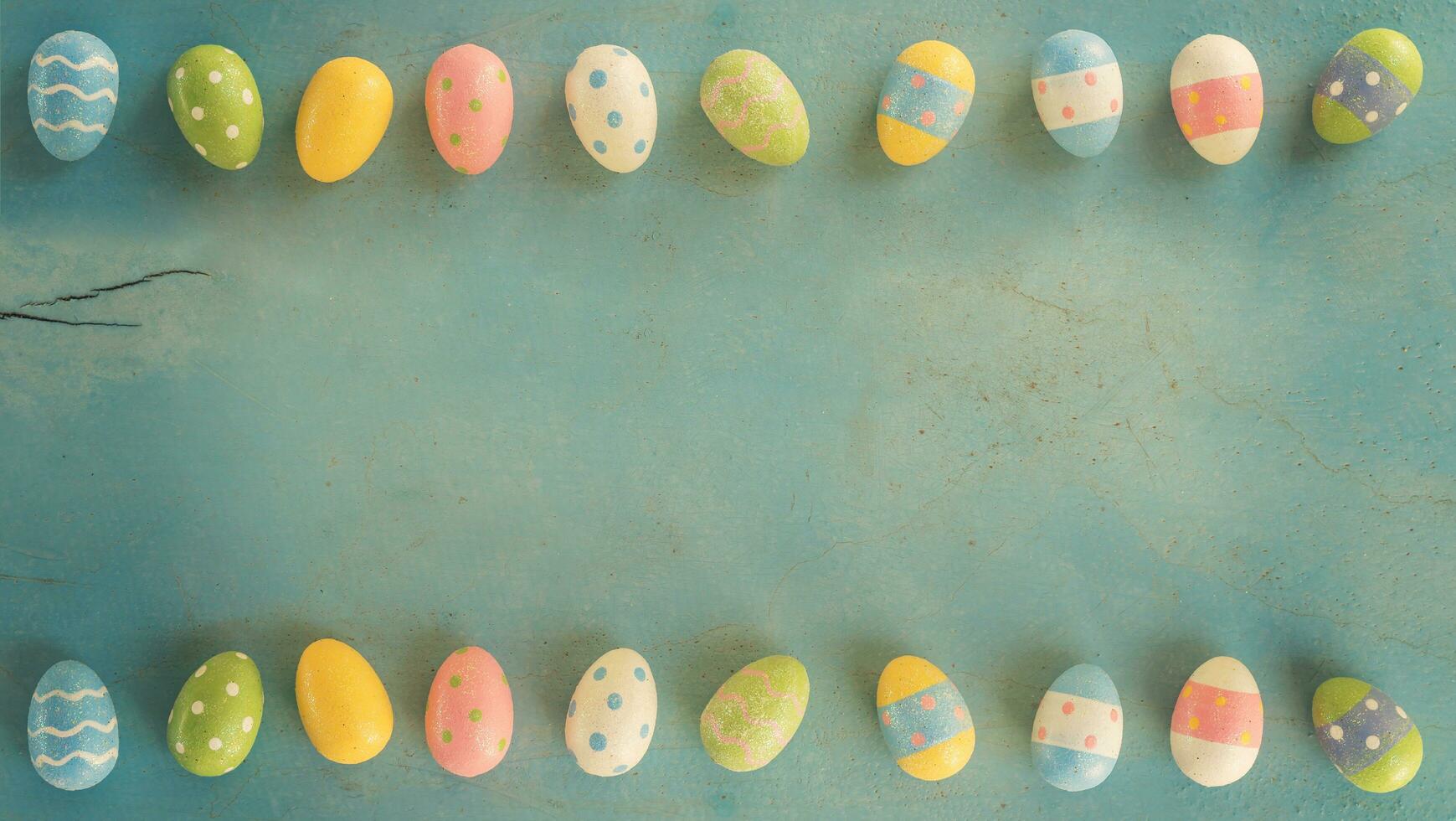 Colorful easter eggs on wooden pastel color background with space. photo