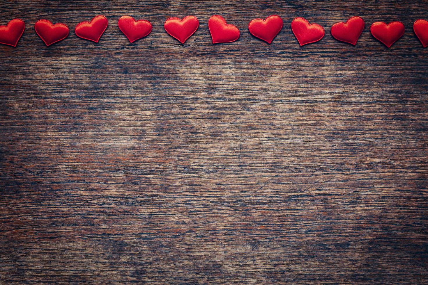 Red heart on wood background with space for Valentine Day. photo