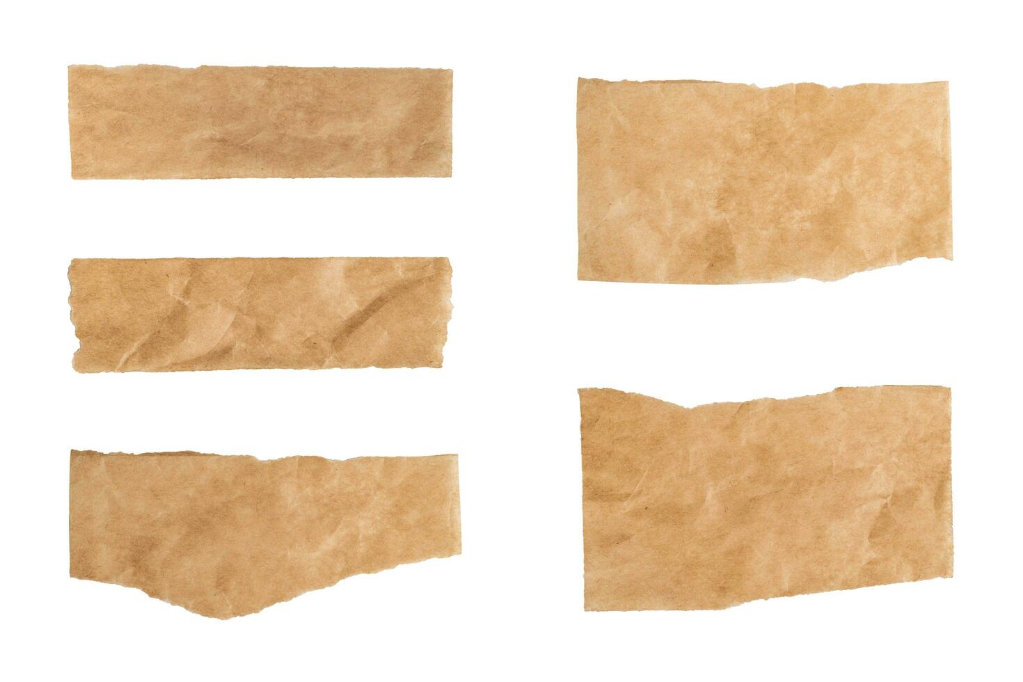 Close up of a ripped piece set of brown paper on white background photo