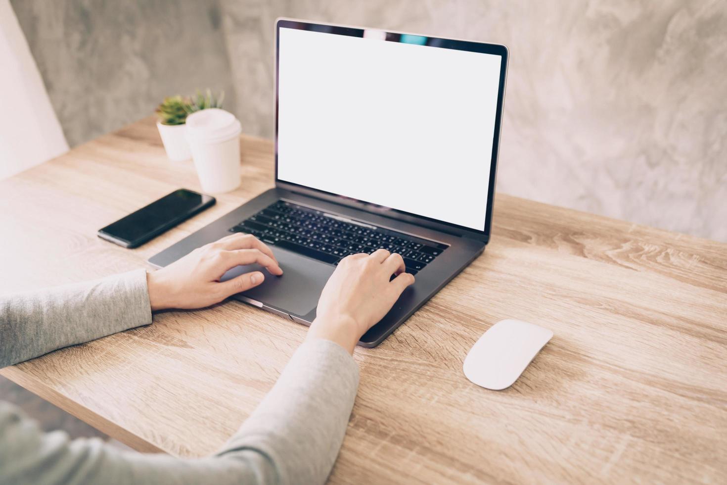Asian woman using computer laptop for working on wooden table photo